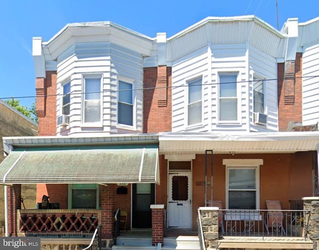 view of front facade featuring a porch and brick siding