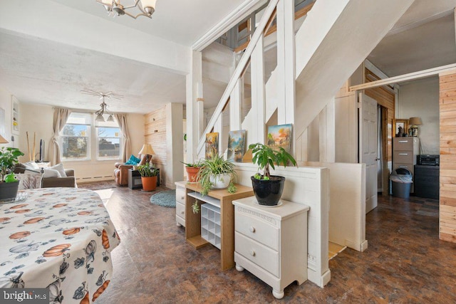 bedroom featuring an inviting chandelier and a baseboard heating unit