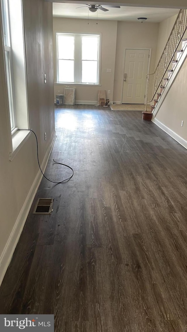 spare room featuring ceiling fan and dark hardwood / wood-style flooring