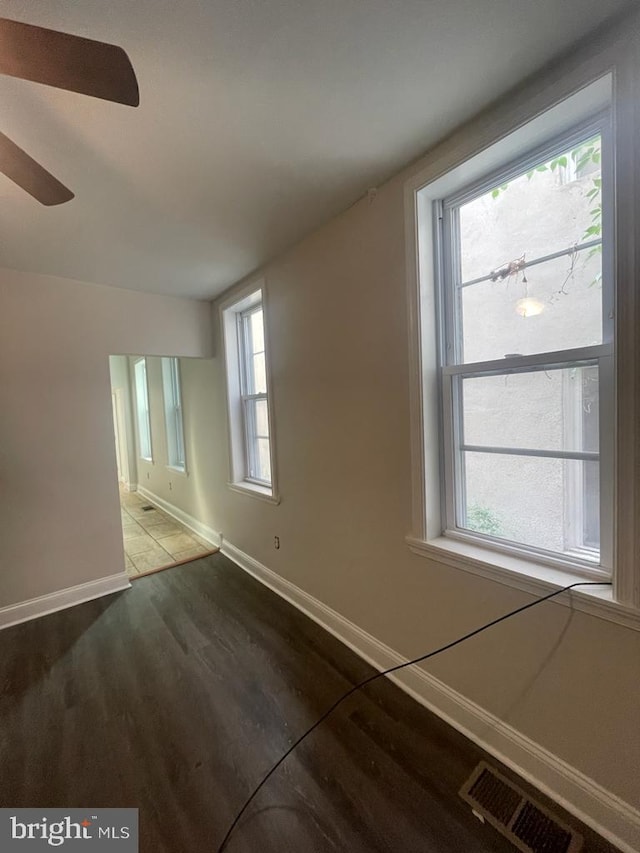 spare room featuring wood-type flooring and ceiling fan