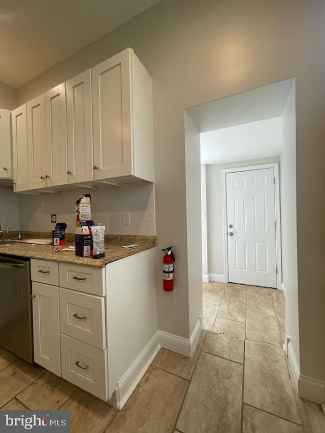 kitchen with dishwasher, white cabinets, and decorative backsplash