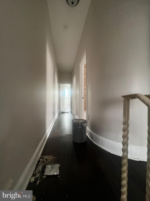 corridor with hardwood / wood-style floors