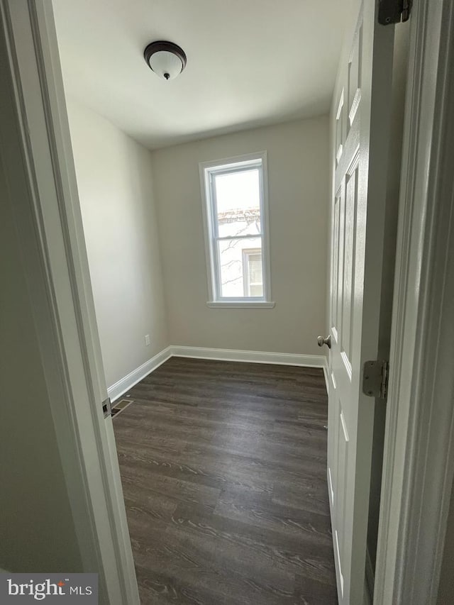 empty room with dark wood-type flooring