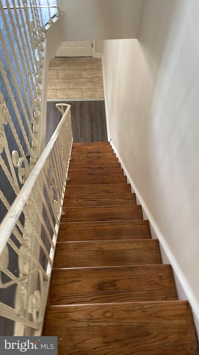 stairs featuring hardwood / wood-style flooring