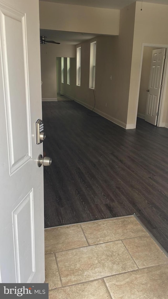 unfurnished room featuring ceiling fan and wood-type flooring