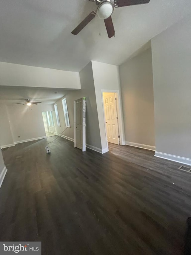 unfurnished living room featuring dark hardwood / wood-style floors and ceiling fan