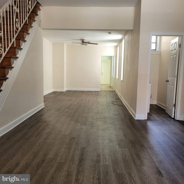 unfurnished living room featuring dark hardwood / wood-style floors and ceiling fan