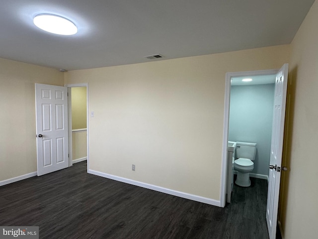 unfurnished bedroom featuring dark hardwood / wood-style flooring