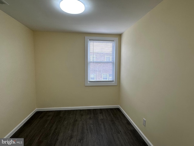 unfurnished room with dark hardwood / wood-style floors