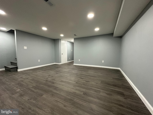 basement with dark hardwood / wood-style floors