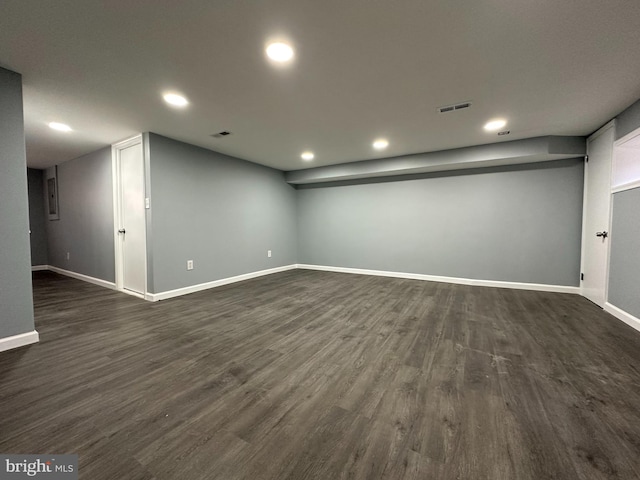 basement with dark hardwood / wood-style floors