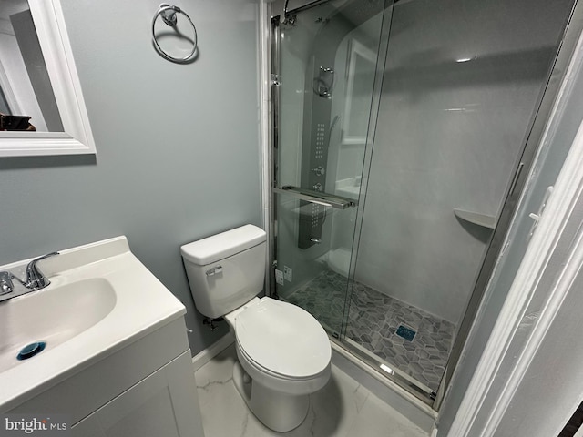 bathroom featuring vanity, toilet, and walk in shower