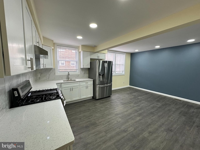 kitchen with white cabinetry, sink, a wealth of natural light, and appliances with stainless steel finishes