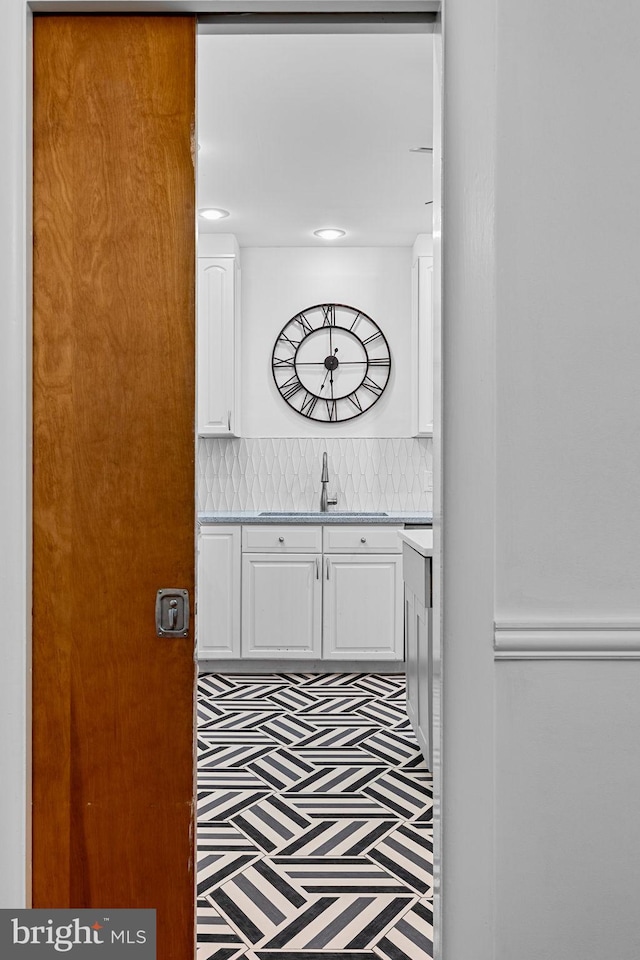 interior space featuring tasteful backsplash and sink