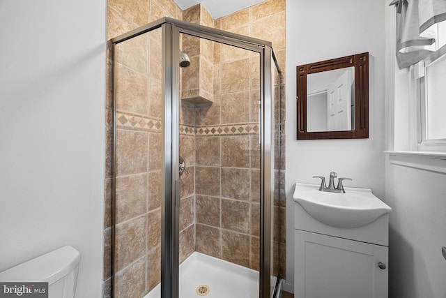 bathroom with vanity, toilet, and walk in shower