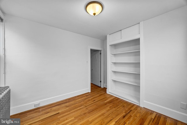 unfurnished bedroom with light hardwood / wood-style floors and a closet