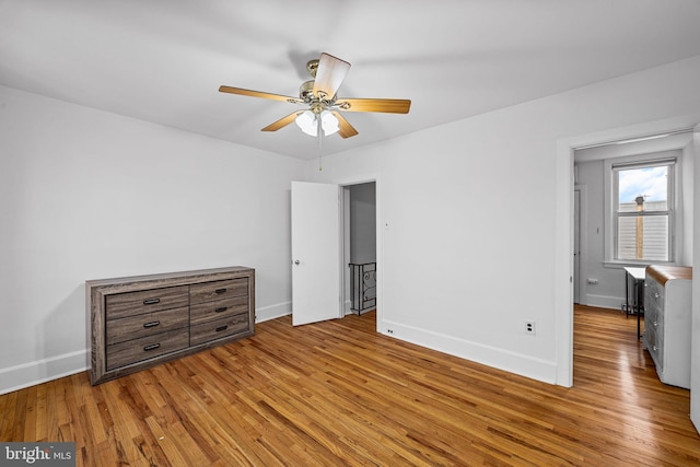 unfurnished bedroom with ceiling fan and light hardwood / wood-style floors