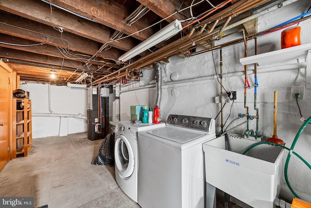 washroom featuring separate washer and dryer, sink, and heating unit