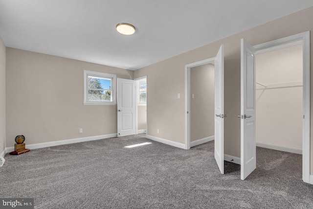 interior space with carpet flooring and baseboards