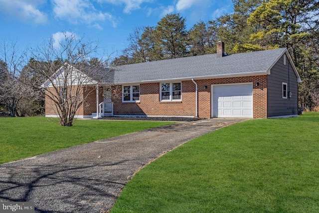 ranch-style house with an attached garage, a chimney, a front lawn, and brick siding