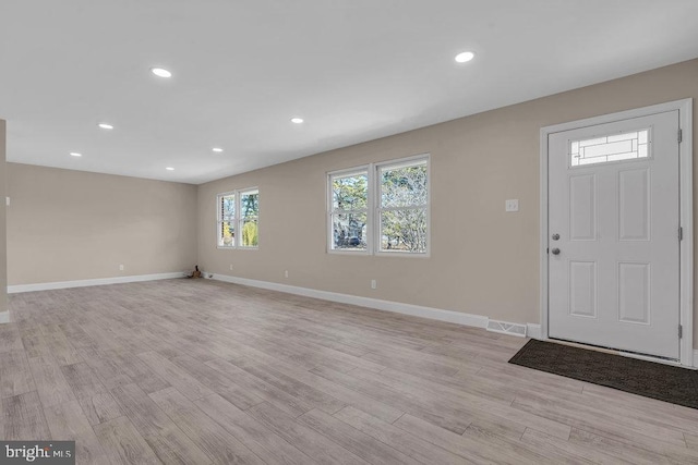 foyer entrance featuring light wood finished floors, recessed lighting, visible vents, and baseboards