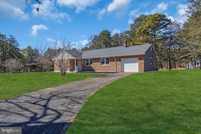 single story home with a front lawn, an attached garage, brick siding, and aphalt driveway