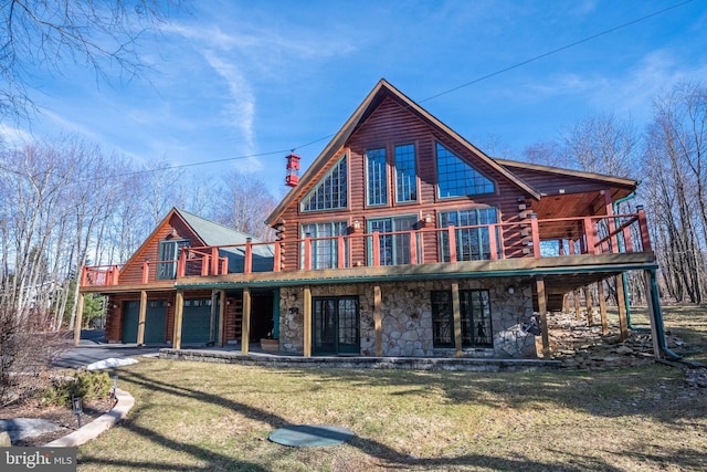 back of property featuring log siding, a chimney, stone siding, a deck, and a lawn