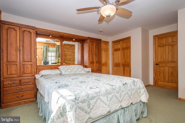 bedroom with light carpet, ceiling fan, and baseboards