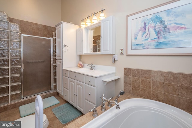 bathroom featuring vanity, a garden tub, toilet, and a stall shower