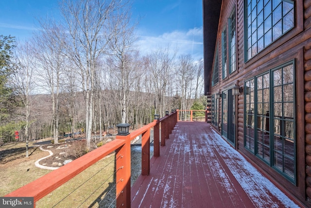 wooden deck with a view of trees