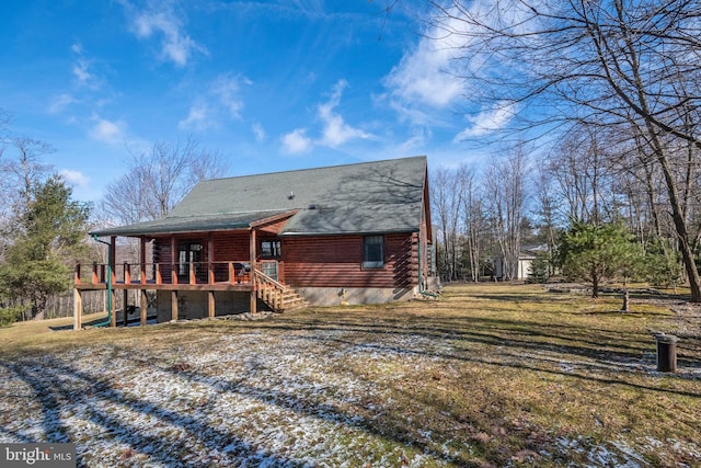 rear view of property with a wooden deck, a lawn, log exterior, and stairs