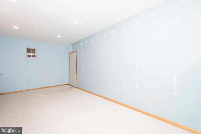 unfurnished room with recessed lighting, baseboards, and light colored carpet