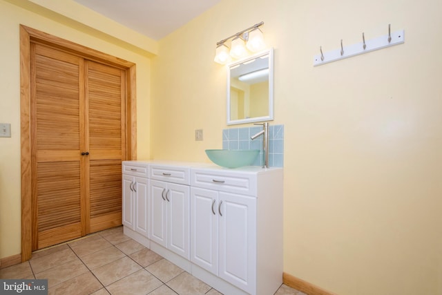 bathroom featuring tile patterned floors, baseboards, and vanity