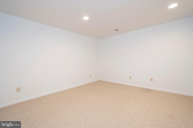 unfurnished room with recessed lighting, light colored carpet, and baseboards