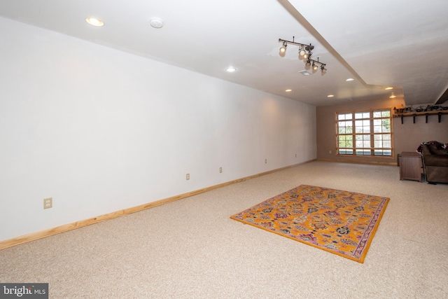 unfurnished living room featuring recessed lighting, baseboards, carpet, and track lighting