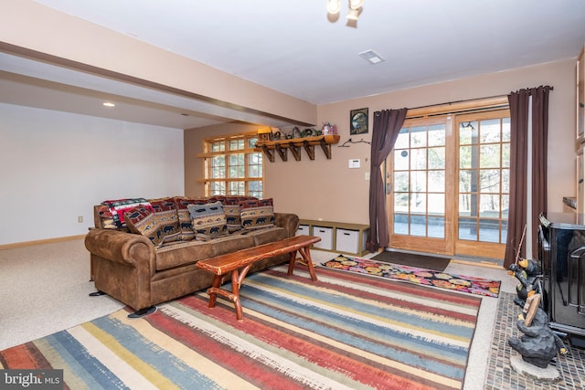 living room featuring visible vents, carpet floors, and baseboards