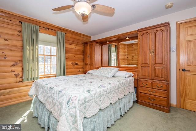 bedroom with light carpet, rustic walls, and ceiling fan