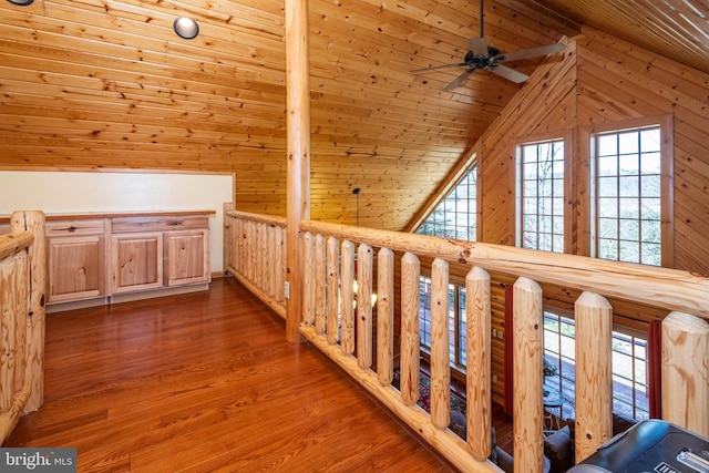 corridor with plenty of natural light, wood walls, wood ceiling, and wood finished floors