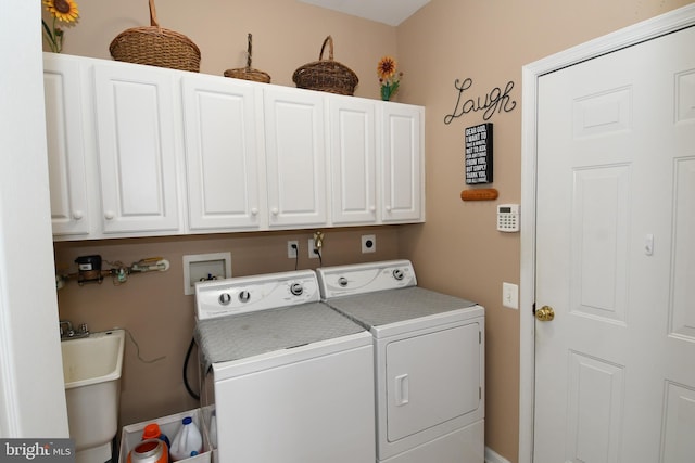 laundry room with sink, cabinets, and washing machine and dryer