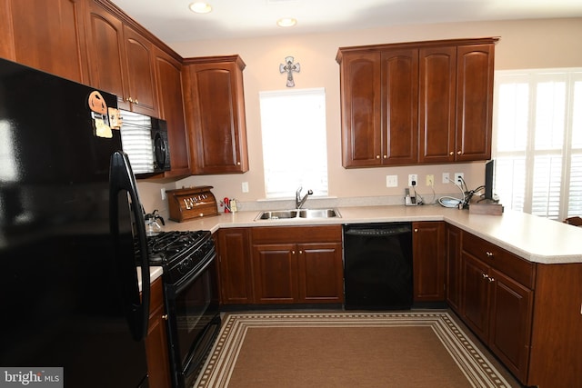 kitchen featuring sink, black appliances, and kitchen peninsula