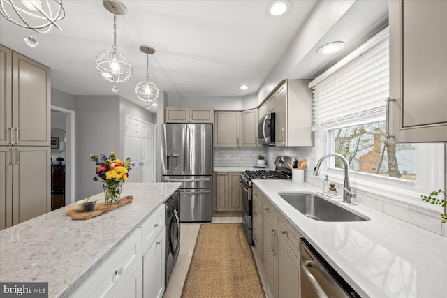 kitchen featuring stainless steel appliances, recessed lighting, hanging light fixtures, backsplash, and a sink