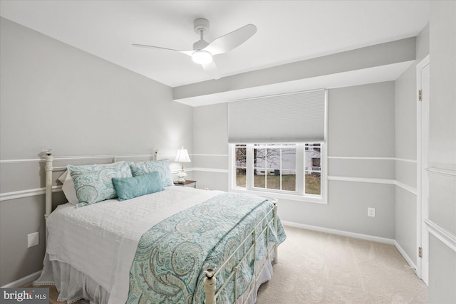 carpeted bedroom with baseboards and a ceiling fan