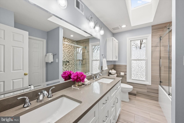 bathroom with visible vents, a sink, and a tile shower