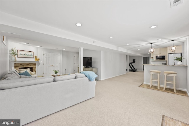 living room featuring recessed lighting, light carpet, visible vents, and baseboards