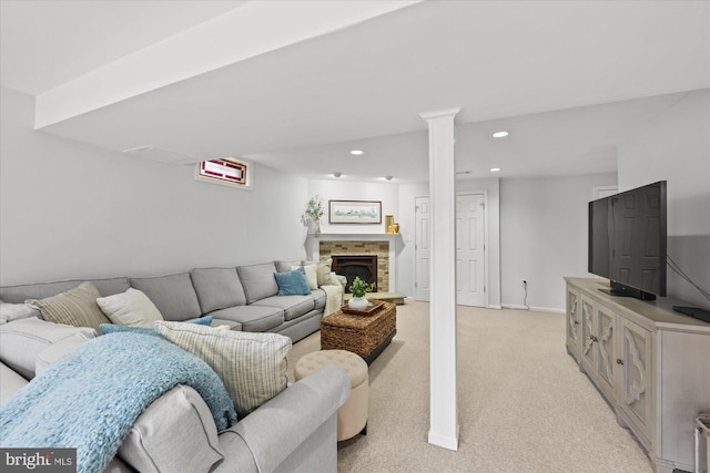 living room with baseboards, a stone fireplace, recessed lighting, and light colored carpet