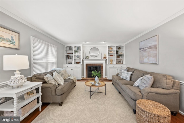 living area featuring ornamental molding, a fireplace, and wood finished floors