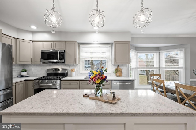 kitchen with stainless steel appliances, tasteful backsplash, gray cabinets, and light stone counters