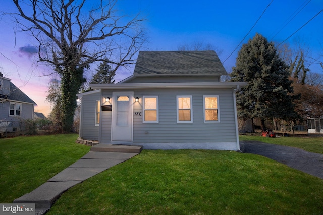 bungalow featuring a lawn