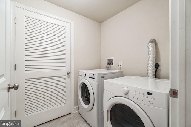 laundry room with light tile patterned floors and washing machine and dryer