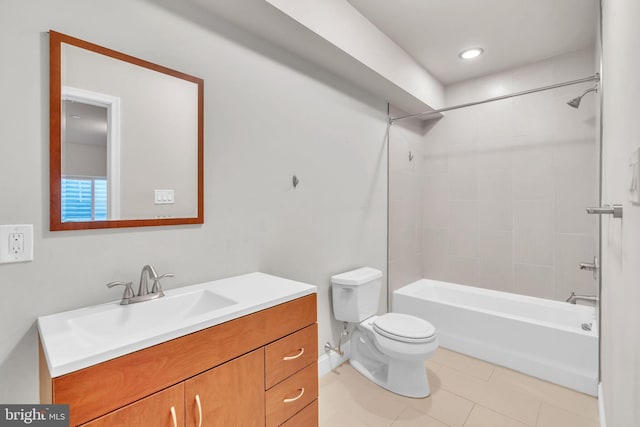 full bathroom with tile patterned flooring, vanity, tiled shower / bath, and toilet